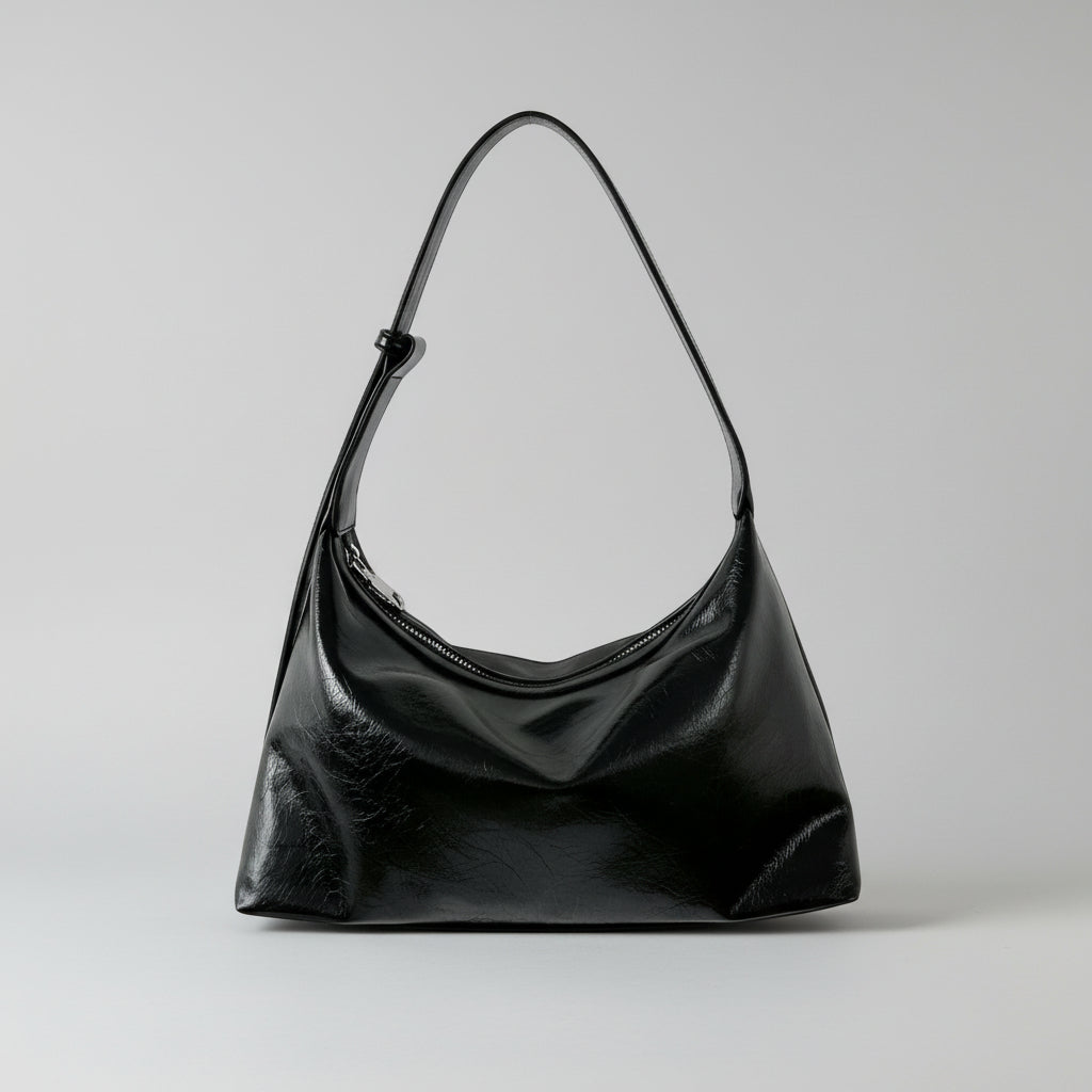 Black smaller handbag on a white background