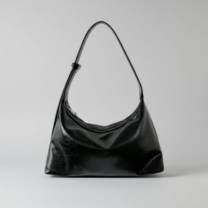 Black smaller handbag on a white background