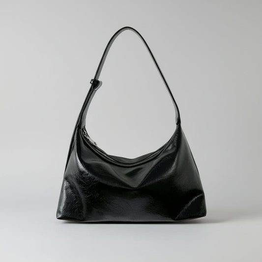 Black smaller handbag on a white background